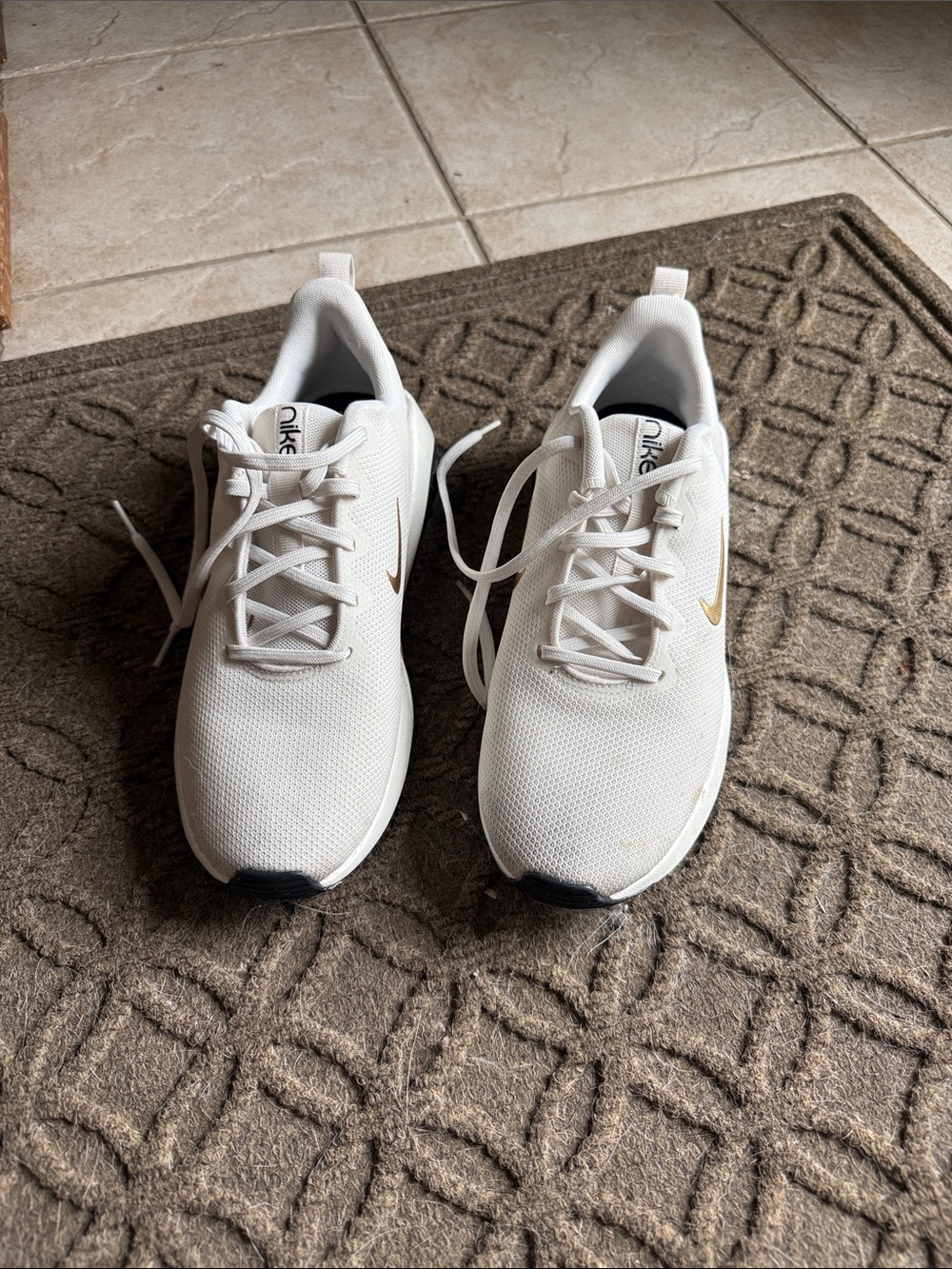 Nike White Mesh Sneakers with Gold Swoosh Accent